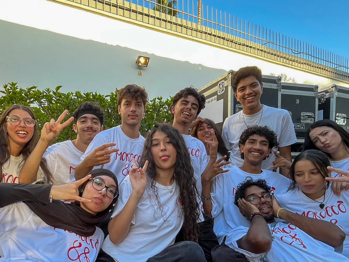 Young people in Morocco88 shirts sitting together outdoors